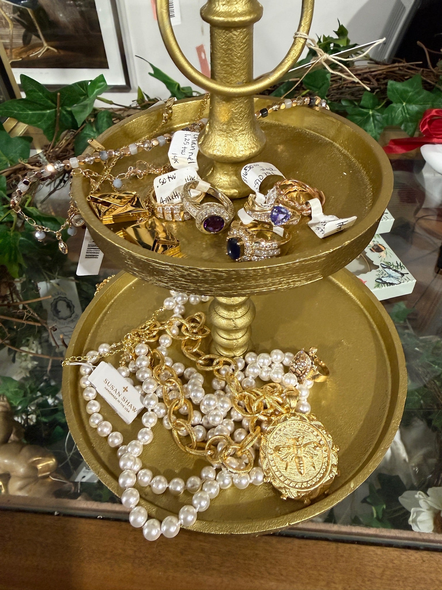 Vintage jewelry on a two-tired gold stand